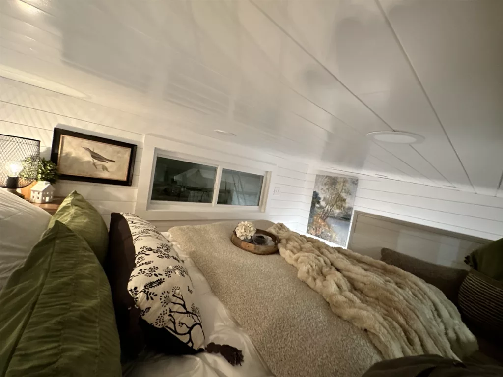 Bed in loft area showing windows