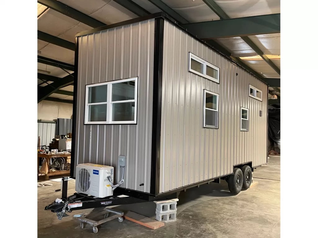 Exterior of tiny home showing window placements and tow hitch