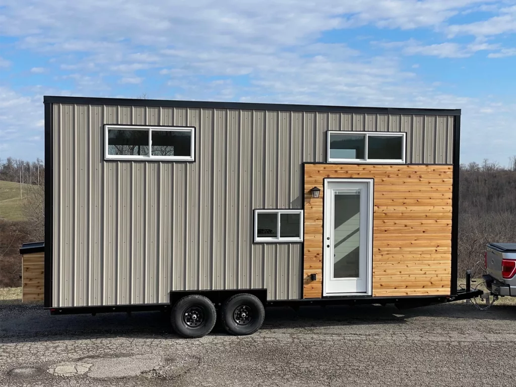 Exterior of tiny home showing door and siding